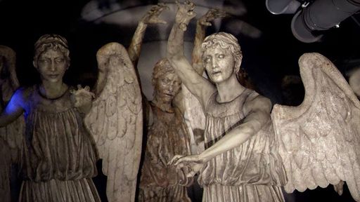 Stone statues of angels with menacing poses